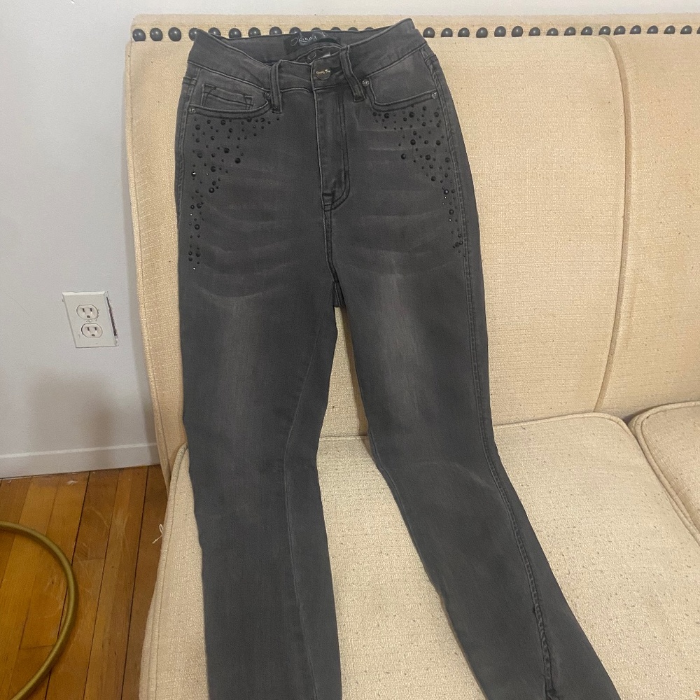 Black denim jeans with black crystals on pockets